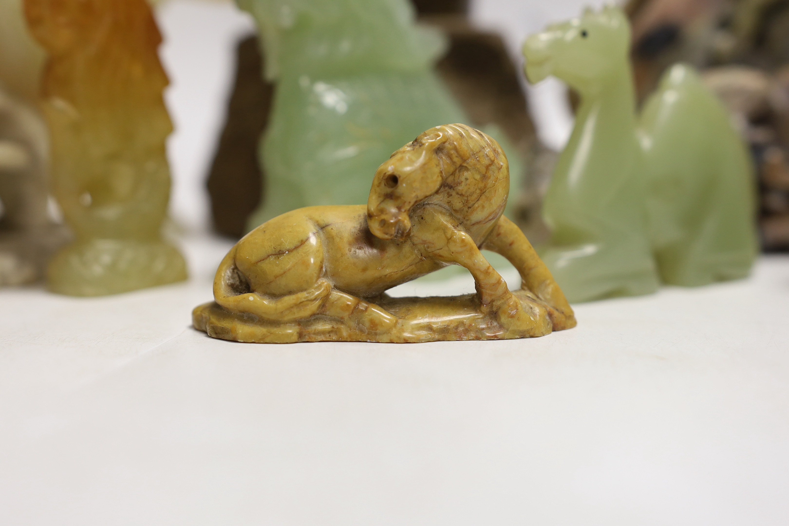 A Cornish serpentine novelty lighthouse lamp and mixed soapstone and hard stone carvings (12), lamp 25cm high